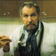 Vincent Price in the kitchen holding a spoon